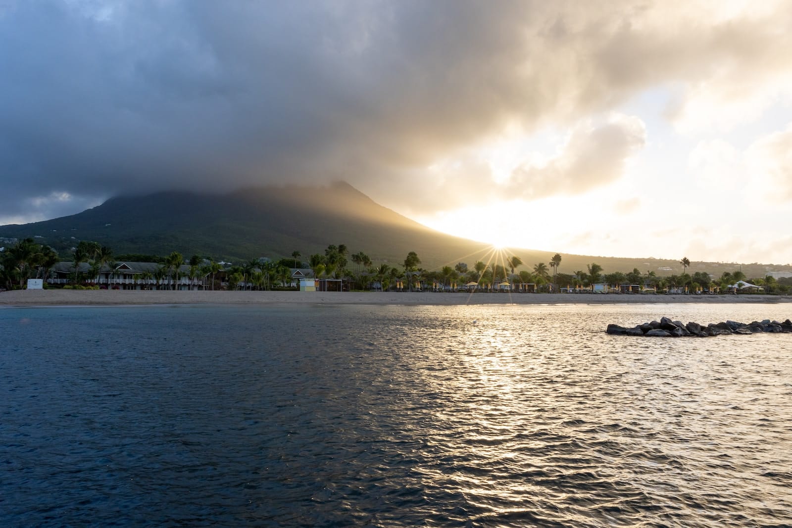 a large body of water with a mountain in the background