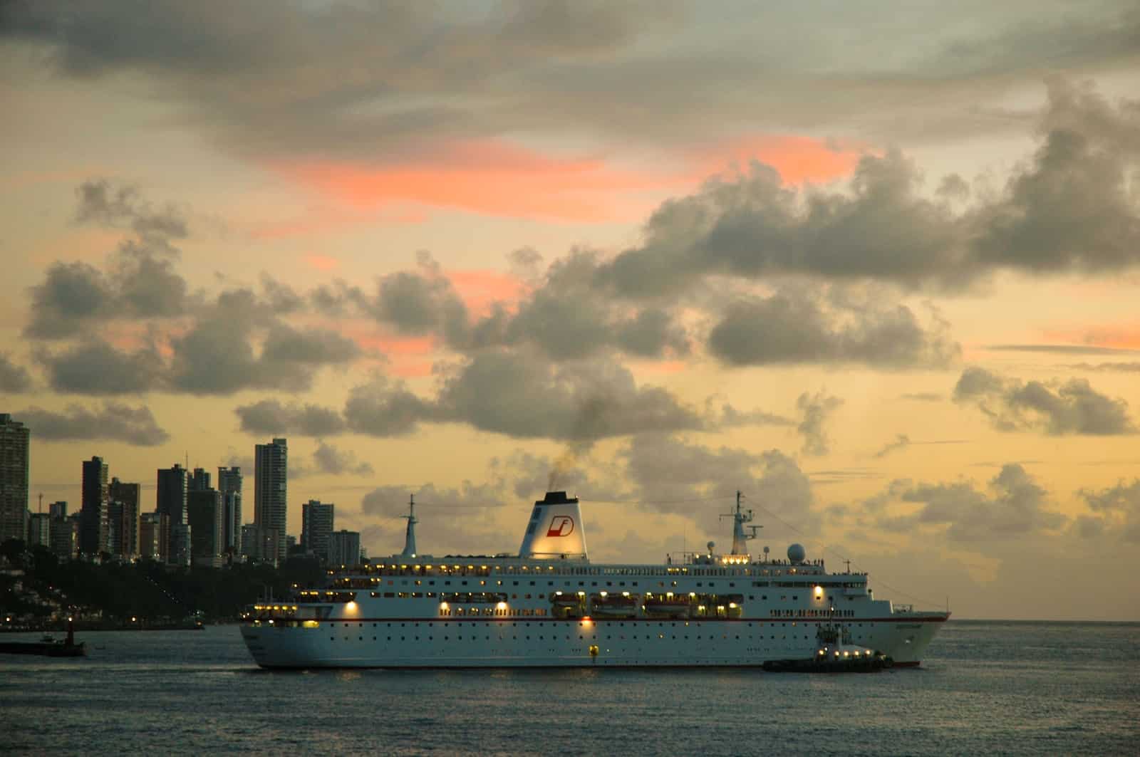 white cruise ship on sea under cloudy sky during daytime